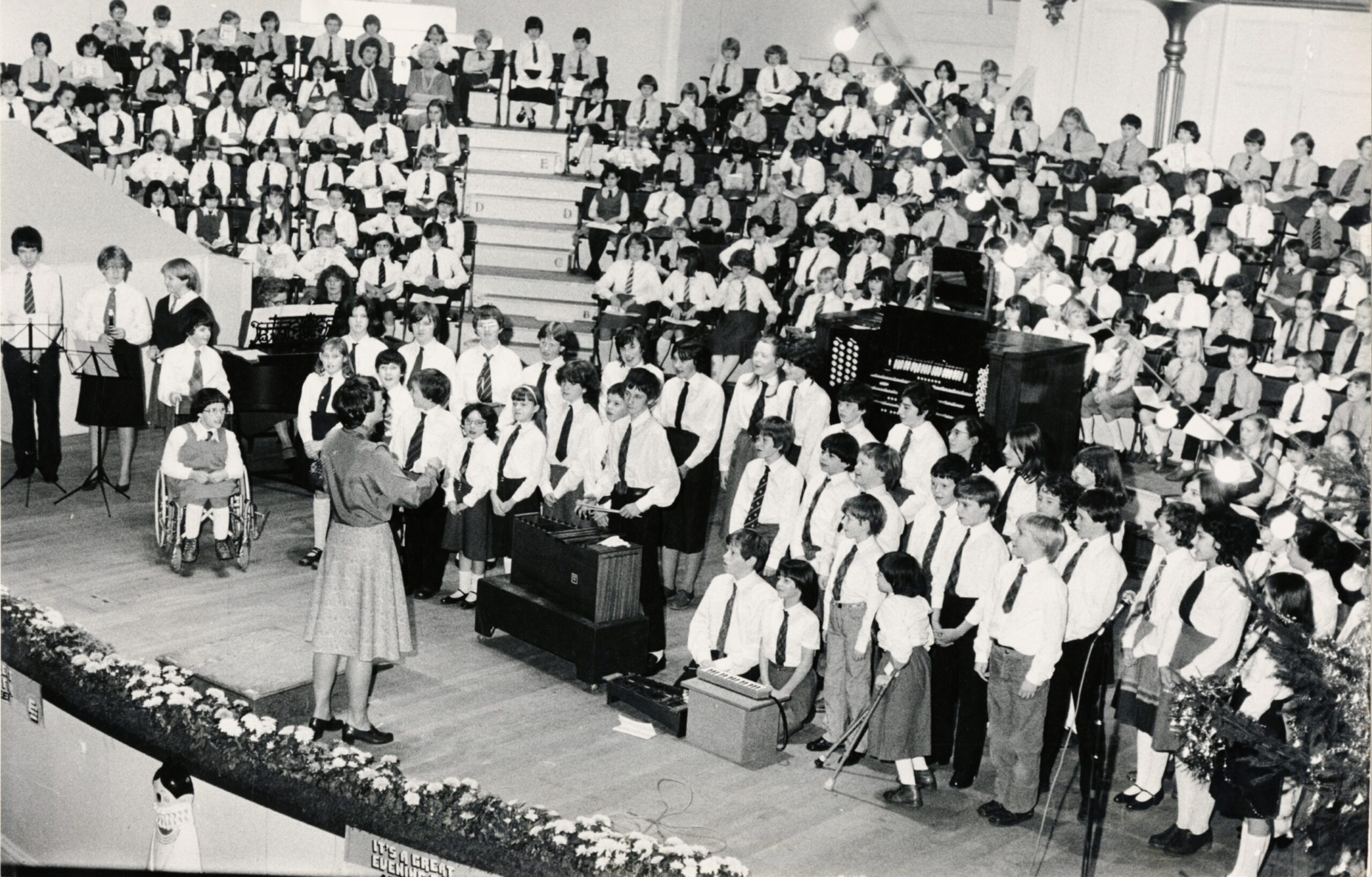 Beechwood School choir with a teacher conducting them