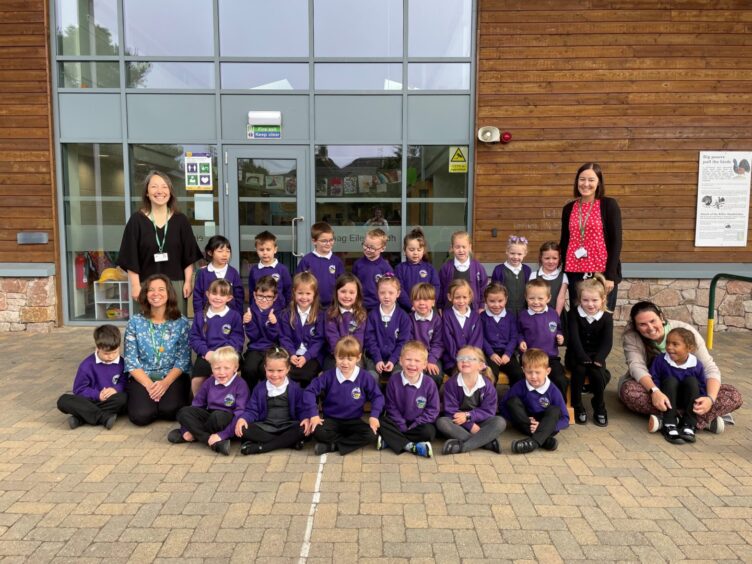 Aviemore Primary School's P1 pupils in rows outside the building with four members of staff