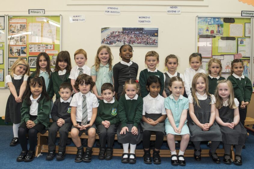 First class of 2023 at Broomhill Primary School in Aberdeen city. The pupils are in two rows, the front row are sitting on a bench 
