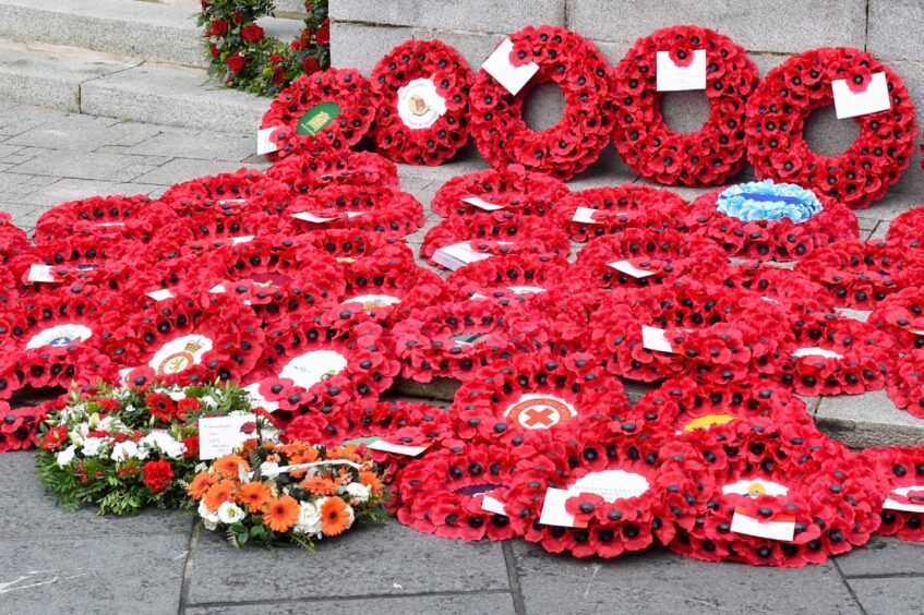 Poppy wreaths have been laid outside Cowdray Hall
