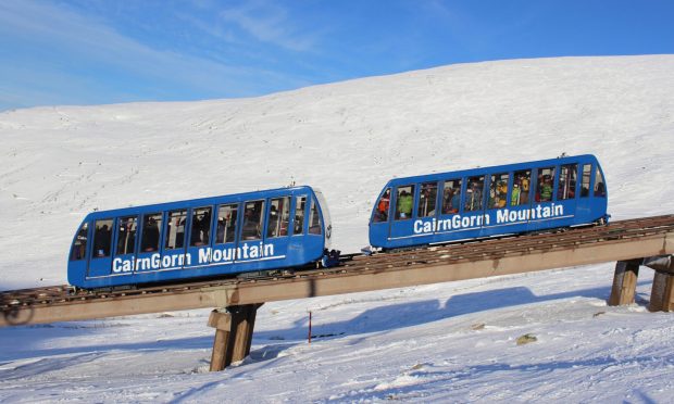 Blue train carriages operating on the funicular on Cairngorm Mountain.