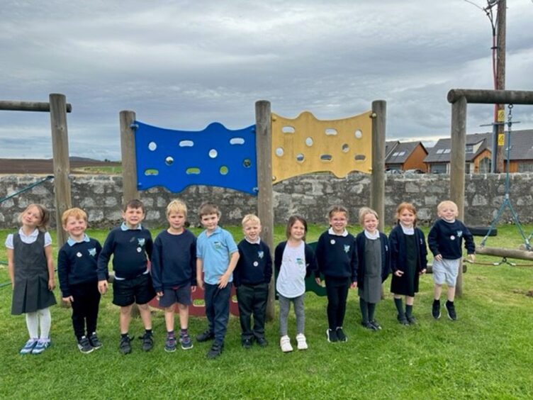 Cluny School primary 1 pupils standing in a line in the playground