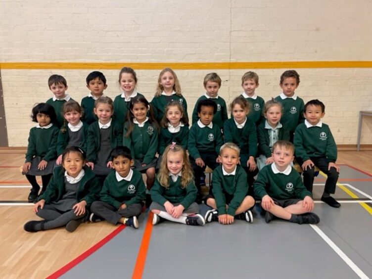 Cults Primary School's class P1M in three rows in the gym hall