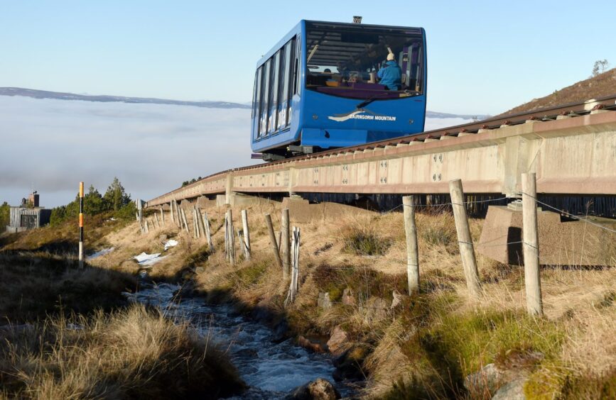 A blue train carriage operating on the Cairngorm funicular on Cairngorm Mountain.