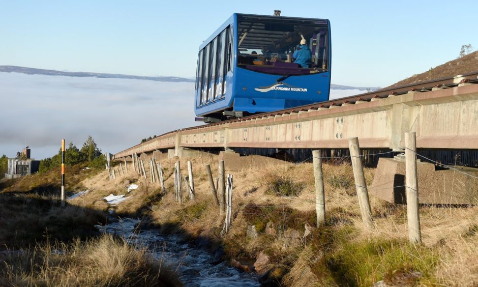 A blue train carriage operating on the Cairngorm funicular on Cairngorm Mountain.