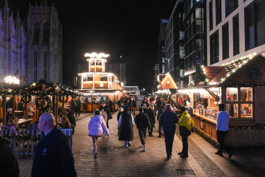 people look at the stalls at Aberdeen Christmas market.