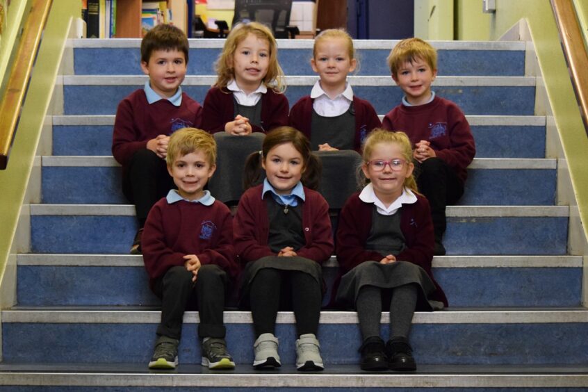 First class 2023 at Daviot Primary School in Aberdeenshire, sitting on a set of stairs