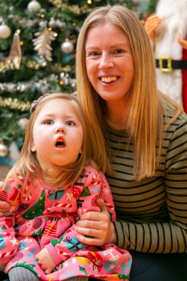 Grace and Evelyn Dennison White from Newtonmore are asking for donations to Chas this Christmas. They are pictured in front of a Christmas Tree.