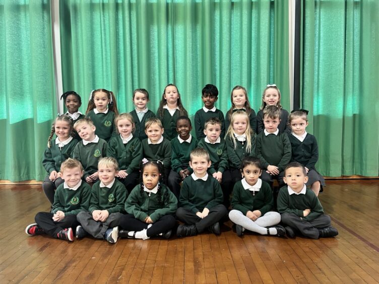 P1 and P2-1 at Fernielea School in three rows, in a hall with green curtains behind them