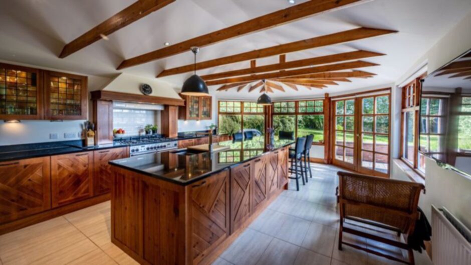 The kitchen boasts floor to ceiling windows.