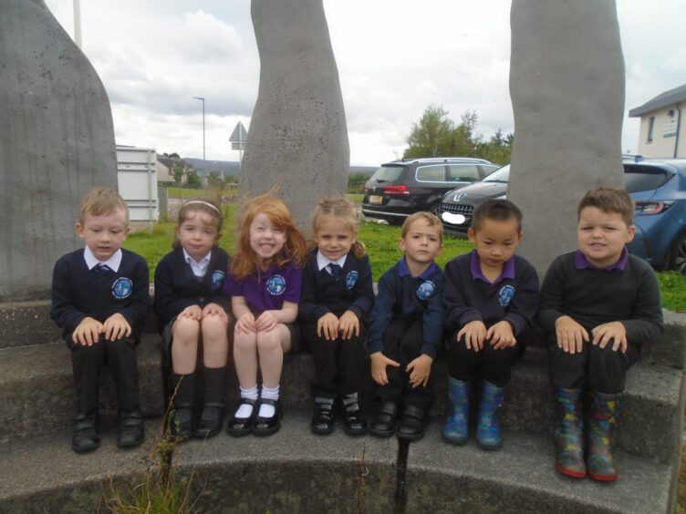 Gairloch Primary School pupils sitting on curved stone steps outside