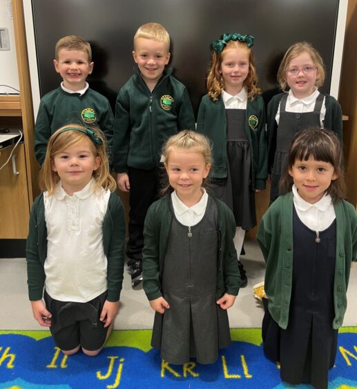 Class P1-2 at Greenbrae School, three girls are kneeling at the front and four pupils are standing behind them