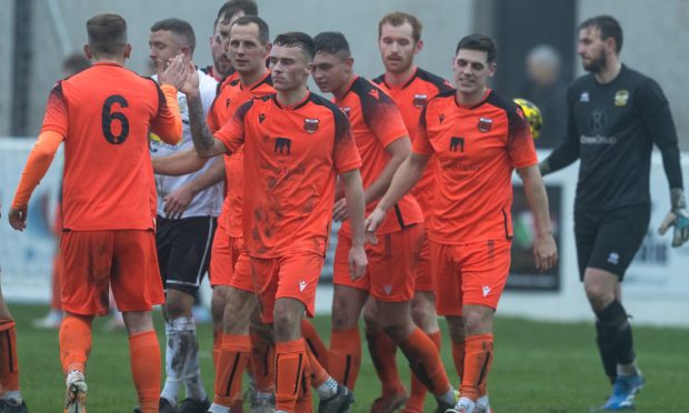 The Rothes players celebrate after scoring against Clachnacuddin. Pictures by Jasperimage