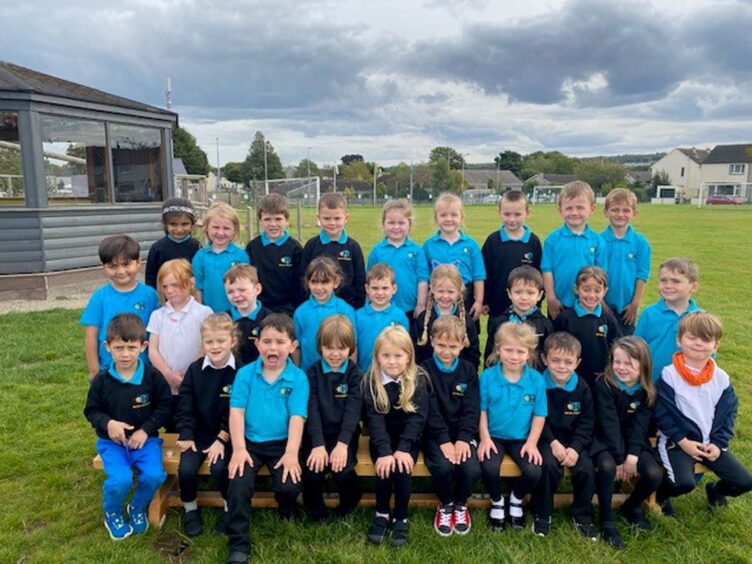 First class of 2023 at Hilton Primary School in the highlands and islands. The children are in three rows outside the school