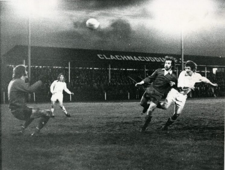 An image from a football match of 1975 when Clach got into the third round of the Scottish Cup. It's Clach v Stirling Albion, and Kennedy (right) gets the ball past Stirling keeper Young.