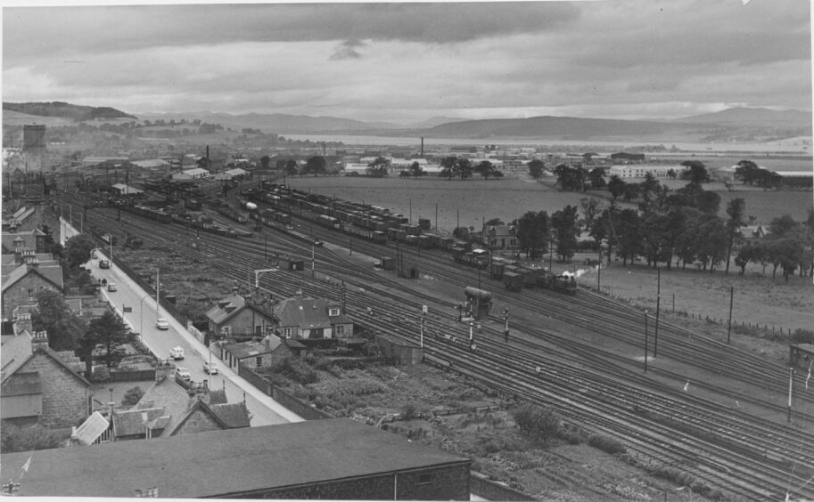A wide view taken in 1960 of Inverness with Millburn Road and the railway line in the foreground, and the Longman and Ness estuary in the background.