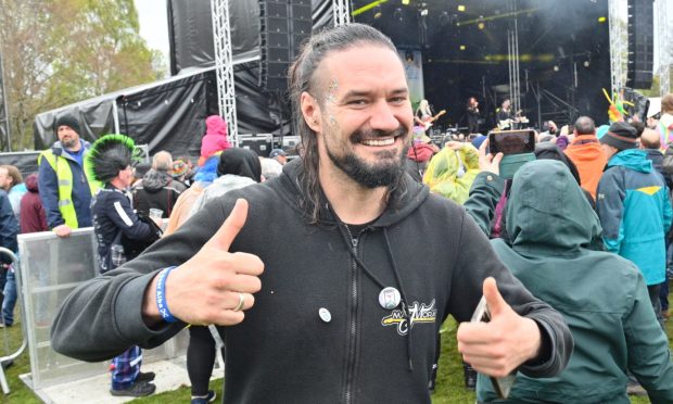 Andy Macdonald smiling at camera with two thumbs up.