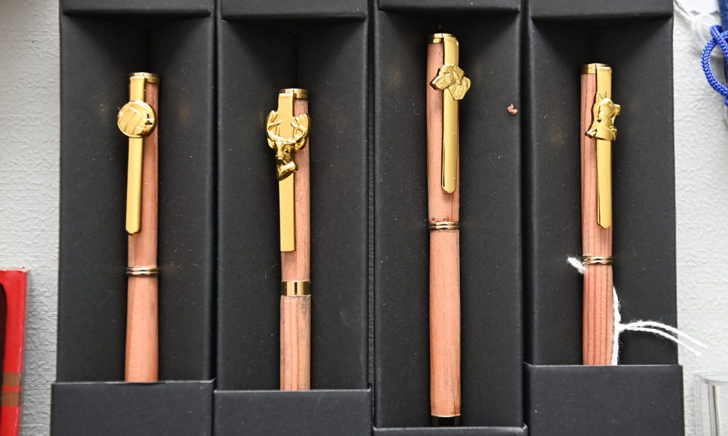 Wooden pens in cases. 