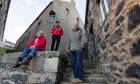 Laura Callan, shop assistant at Portsoy Marble, retail and holiday let manager Susan Rayne and Paul Higson, project director for North East Scotland Preservation Trust, photographed outside few of the derelict buildings at Portsoy harbour that will be renovated.