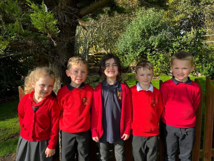 Five Johnshaven School pupils outside surrounded by greenery