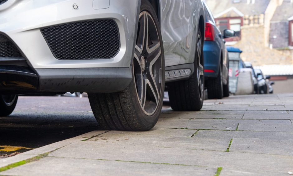 Cars parked on pavements.