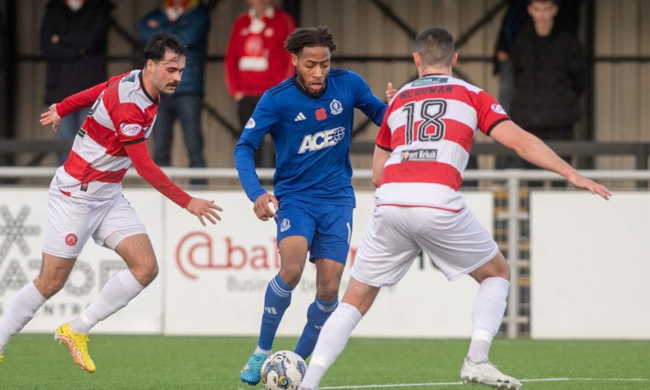Rumarn Burrell in action for Cove Rangers in a match at Balmoral Stadium.