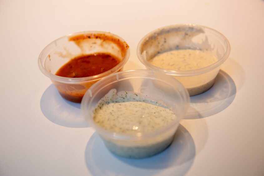 The plastic pots of dips that came with the food.