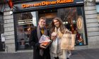 Reporters Andy Morton and Karla Sinclair standing outside the German Doner Kebab on Union Street holding takeaway bags
