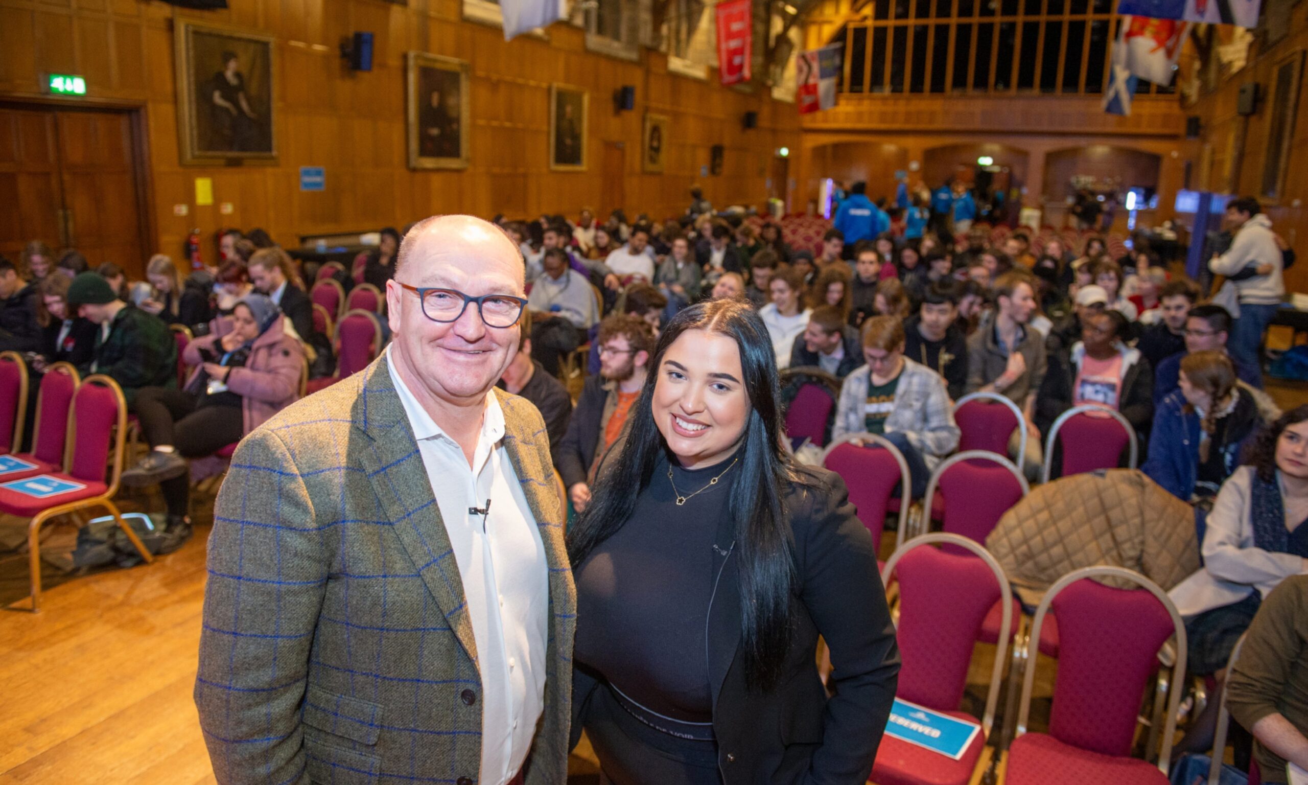 Our Union Street co-founder Derrick Thomson and communications manager Honey Keenan pictured in front of Aberdeen University students at Elphinstone Hall.