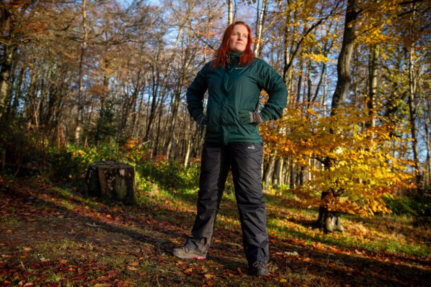 Jennifer, who runs a dance class in Airyhall, standing with her hands on her hips in the forest