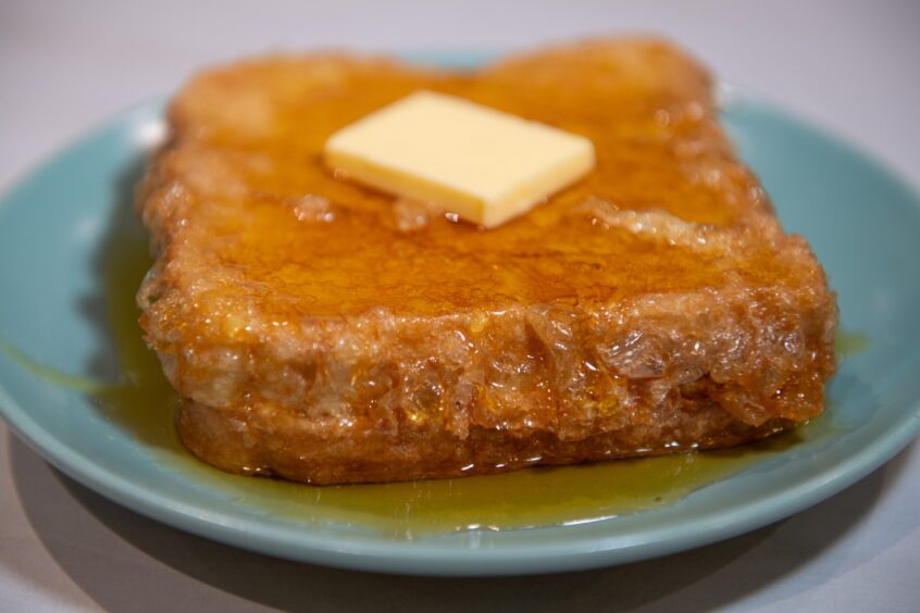French toast with a square of rapidly melting butter on top. 