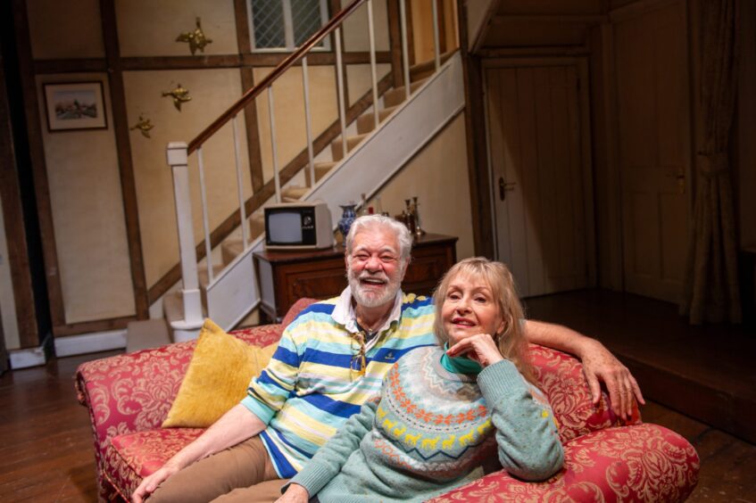 Matthew Kelly and Liza Goddard sitting on a sofa at His Majesty's Theatre.