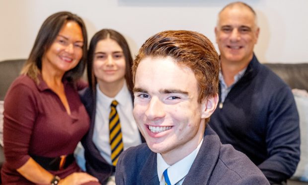 Aiden Leigh, 17, with a very proud family - mum Charmaine, sister Cara and dad Eddie. Image: Kami Thomson/DC Thomson