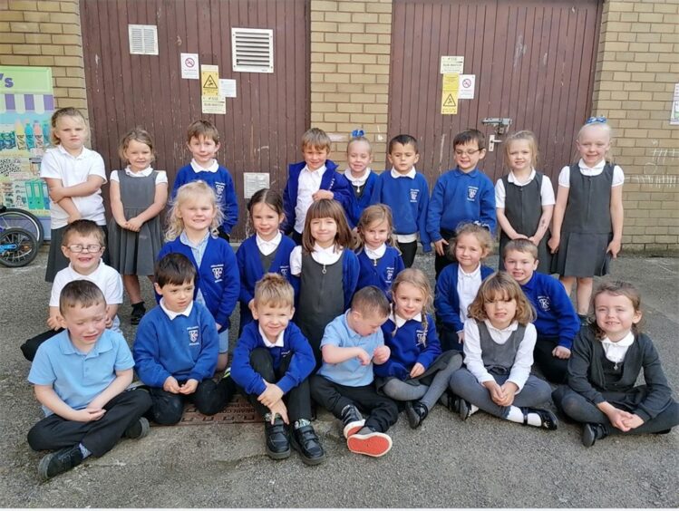Class P1O at Kellands Primary School, sitting outside the school