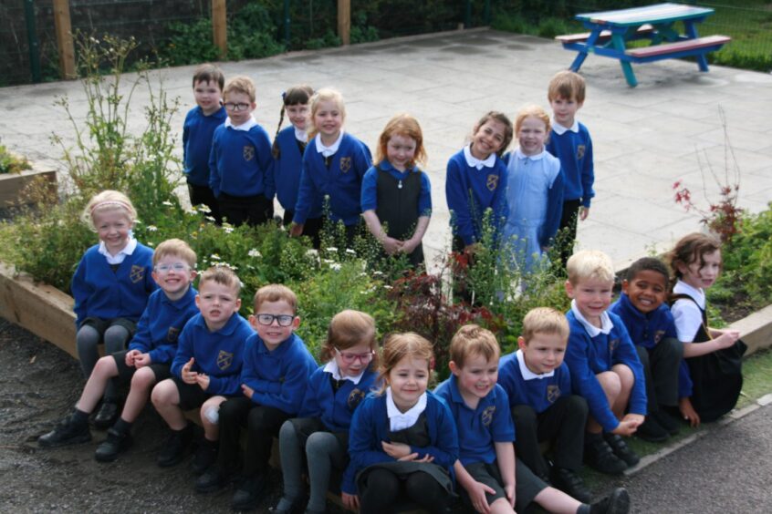 P1K at Kinellar School sitting around planters on the school grounds