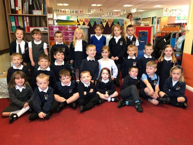 First class of 2023 at Lochpots Primary School in Aberdeenshire. The children are in three rows in their classroom