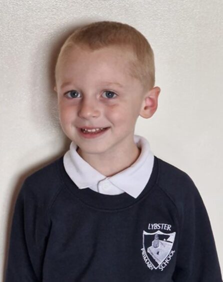 Lybster Primary School's only P1 pupil smiling at the camera