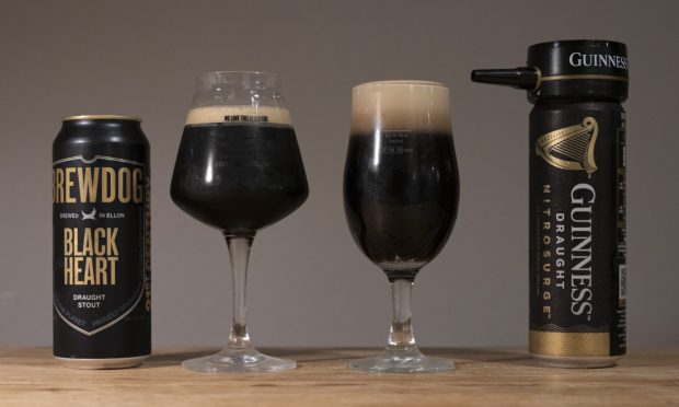 Two glasses of beer, one with Brewdog Black Heart in it, one with Guinness Nitrosurge in it, alongside their corresponding cans.