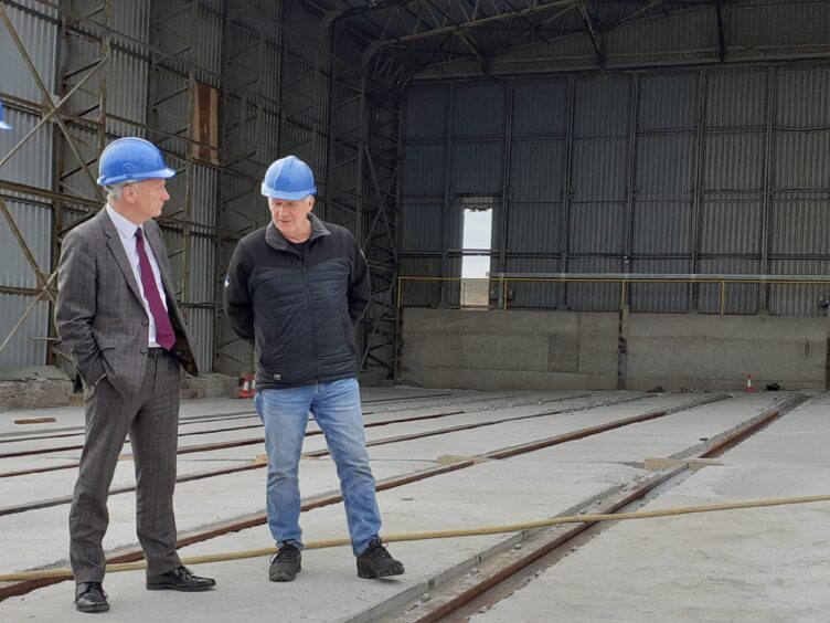 Scottish Government minister Ivan McKee, left, chats to Macduff Shipyards managing director John Watt, during a visit to Buckie last year.