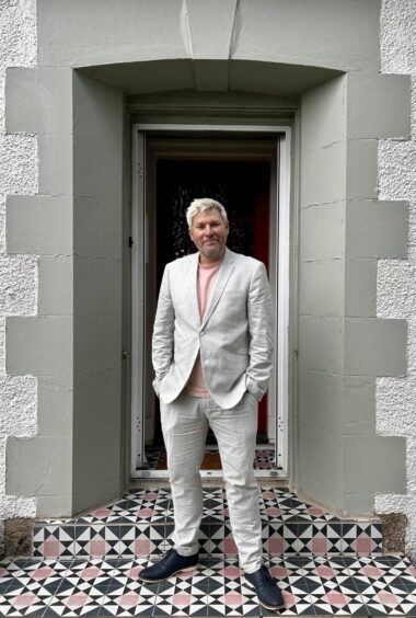 Mark Nelson in a white suit for the launch of his Edinburgh Fringe run earlier this year.