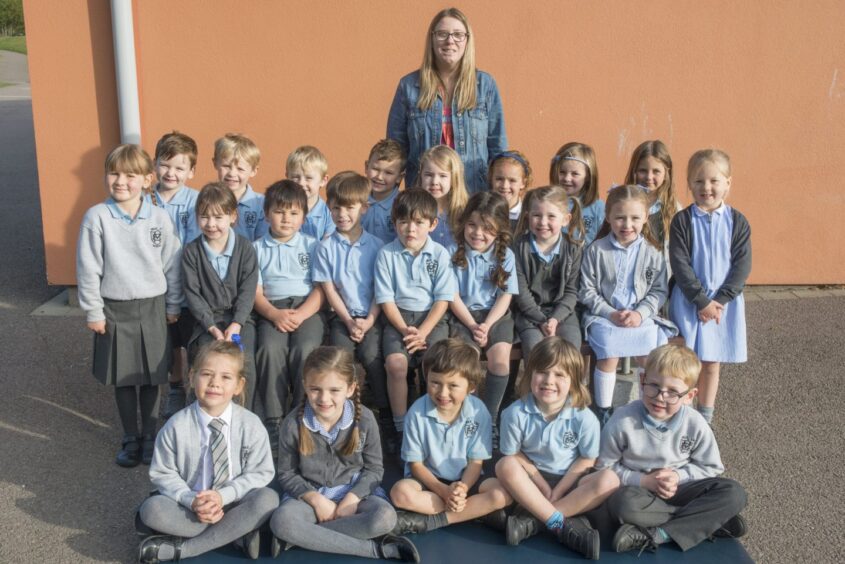 First class of 2023 at Mile End Primary School in Aberdeen. The pupils are in three rows outside the school with their teacher behind them