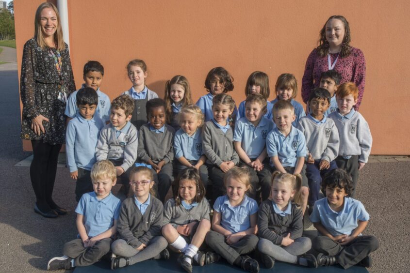 Mile End Primary School's first class of 2023 with two teachers. The photo was taken outside the school