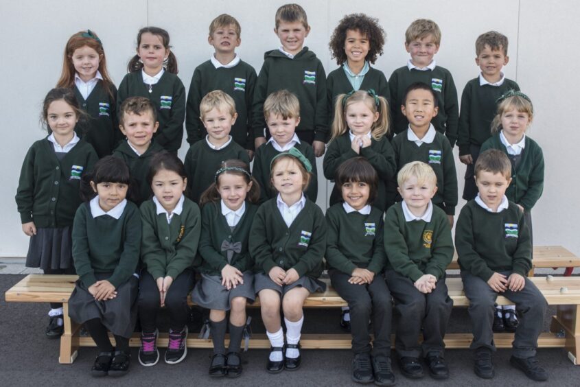 Mrs Parke's First class of 2023 at Milltimber Primary School in Aberdeen. The pupils at in three rows on benches