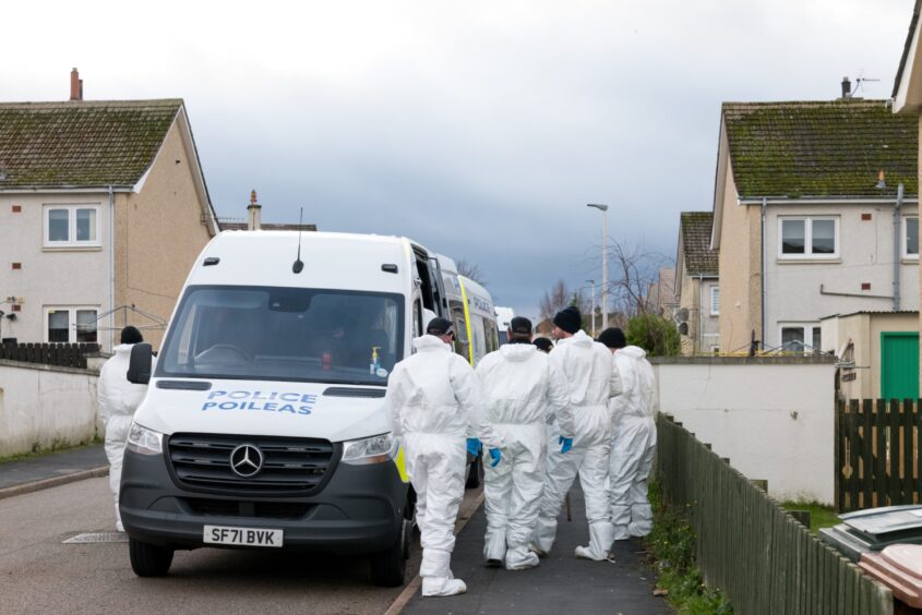 Officers in white forensic suits outside the home in New Elgin where the mother-of-two was murdered.