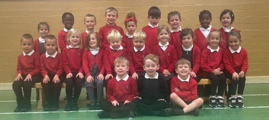 Class P1R at New Machar School, in three rows in the gym hall