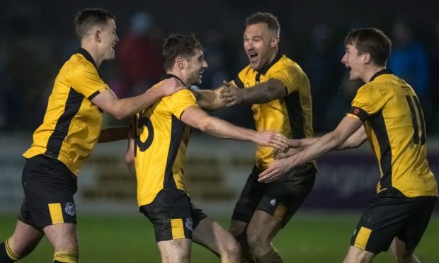 Wayne Mackintosh, second from right, celebrates after Ben Kelly, second from left, scored for Nairn County in the North of Scotland Cup final. Pictures by Jasperimage