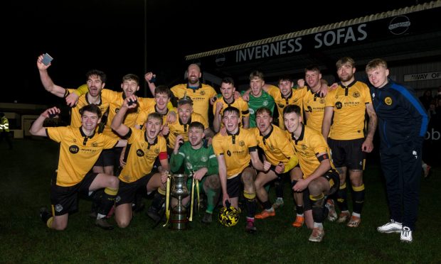 The Nairn County players celebrate with the North of Scotland Cup trophy. Pictures by Jasperimage