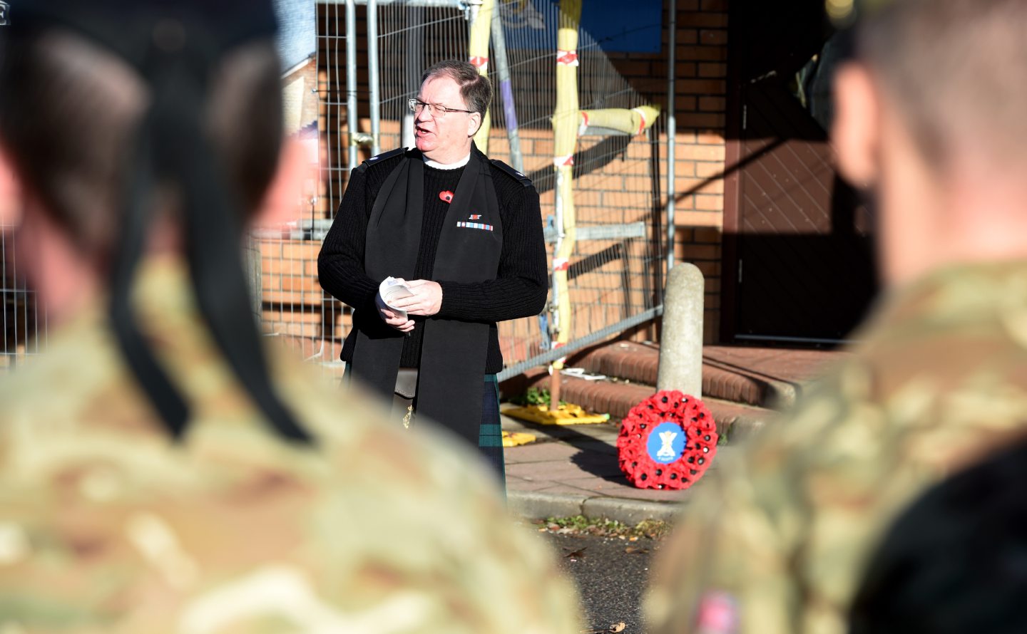 Rev Geoff Berry leads a Remembrance Day service in front of a poppy memorial in Inverness.
