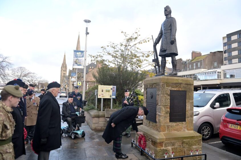 A wreath is laid by WO Tony Curran. <yoastmark class=