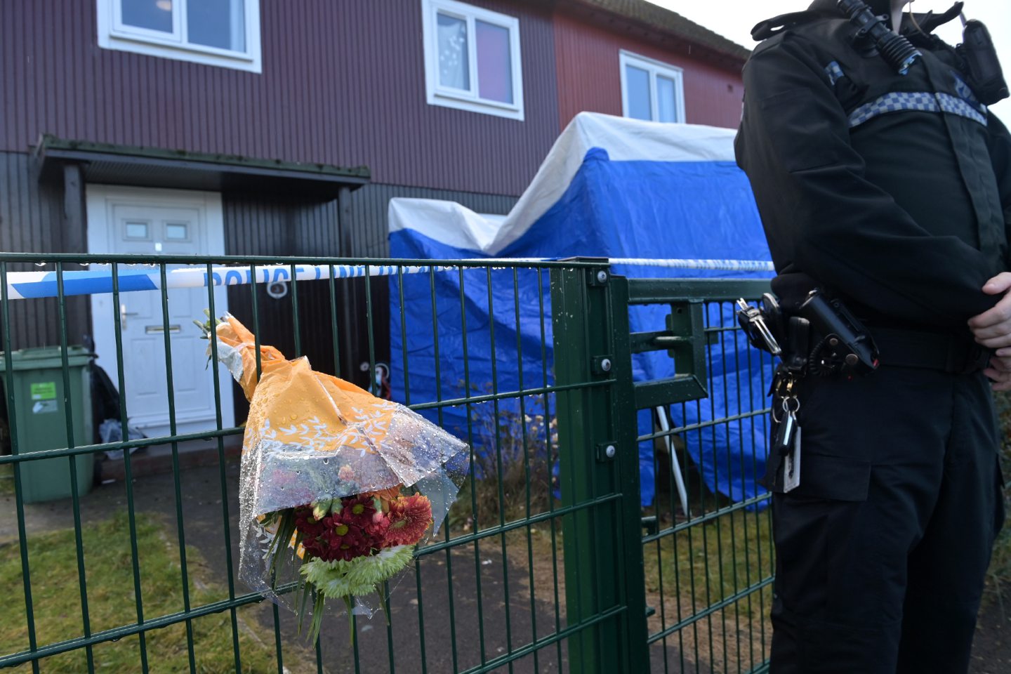 A flower tribute on the fence outside the property on St Ninian Drive, Dalneigh, where Inverness dad Ross MacGillivray was found murdered.